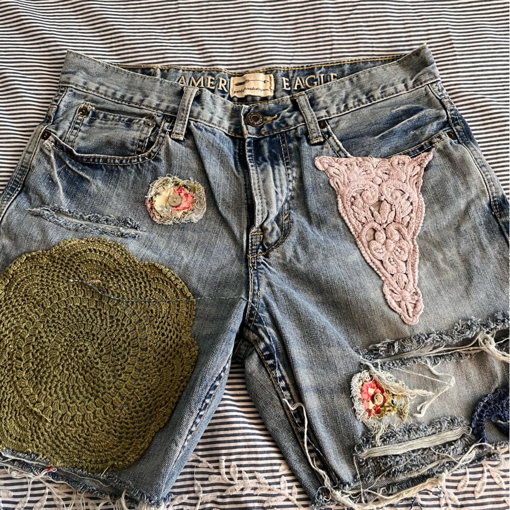 Jean shorts with upcycled embellishments.